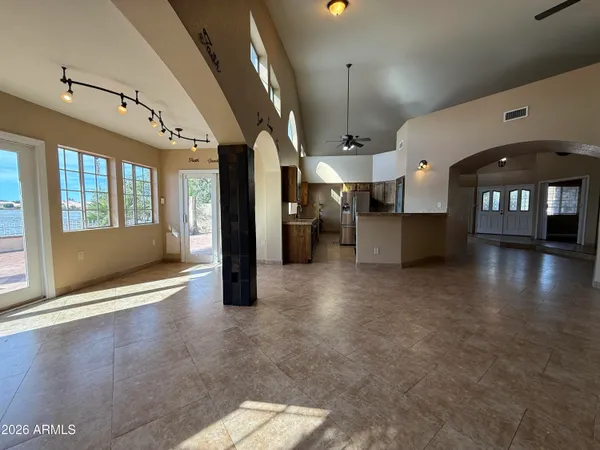 a view of a big room with entryway and windows