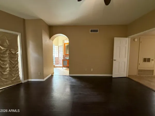 a view of a livingroom with wooden floor and a window