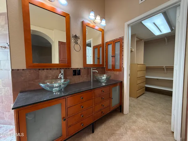 a bathroom with a double vanity sink and a mirror