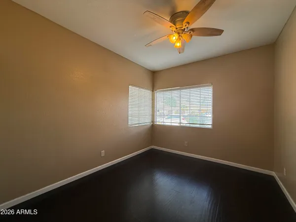 an empty room with wooden floor and closet