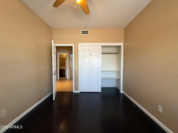 a bathroom with a granite countertop sink a toilet mirror and bathtub