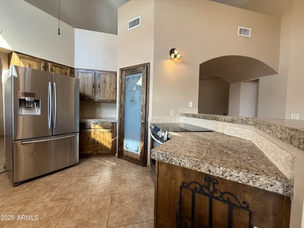 a kitchen with a refrigerator and a sink