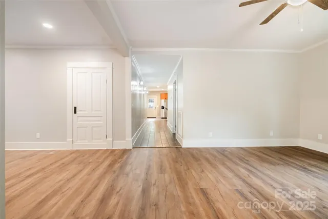a view of a room with wooden floor and white walls