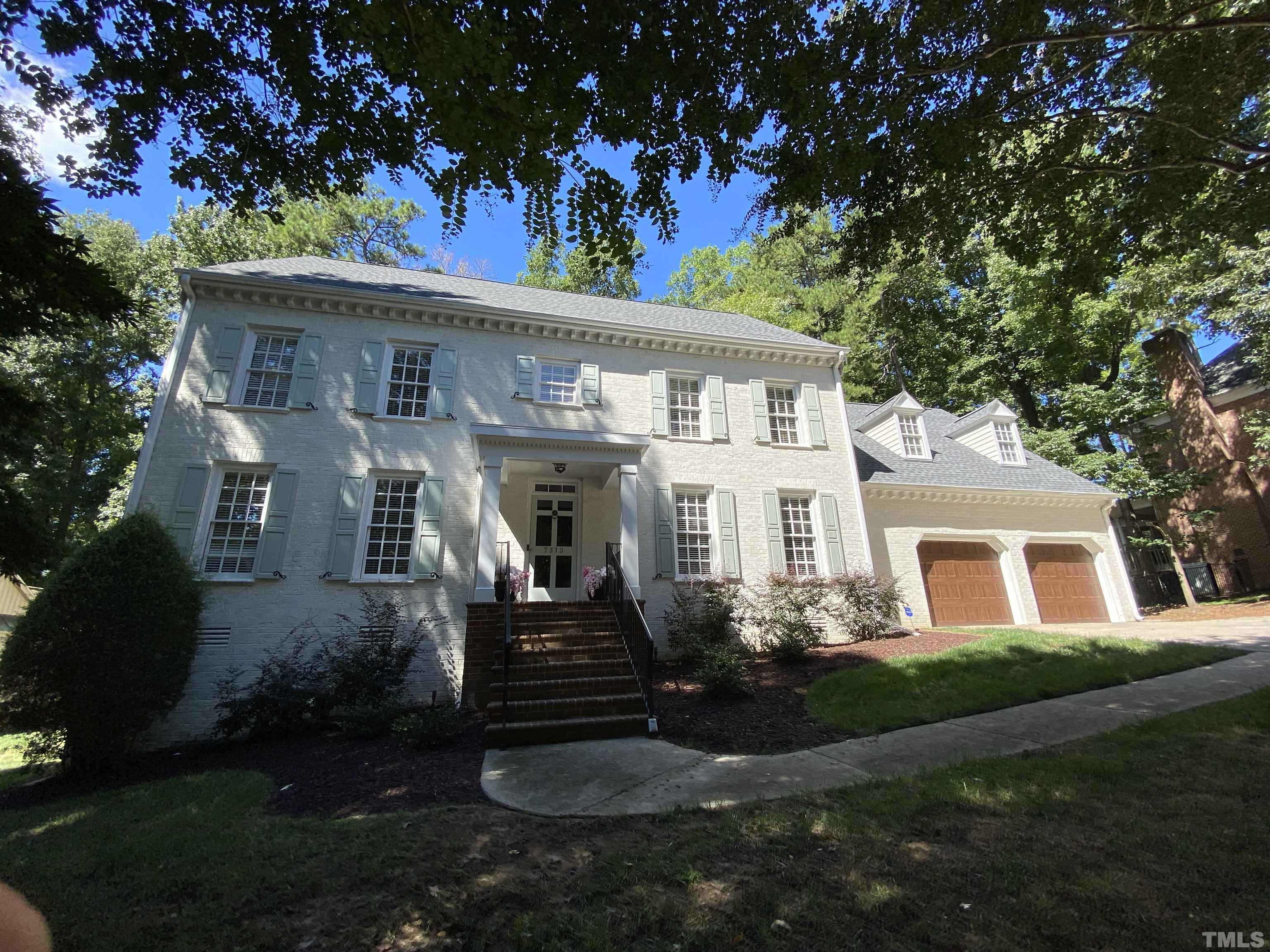 7313 Rainwater Road Raleigh, NC 27615 - Photo 1 of 30 a front view of a house with garden