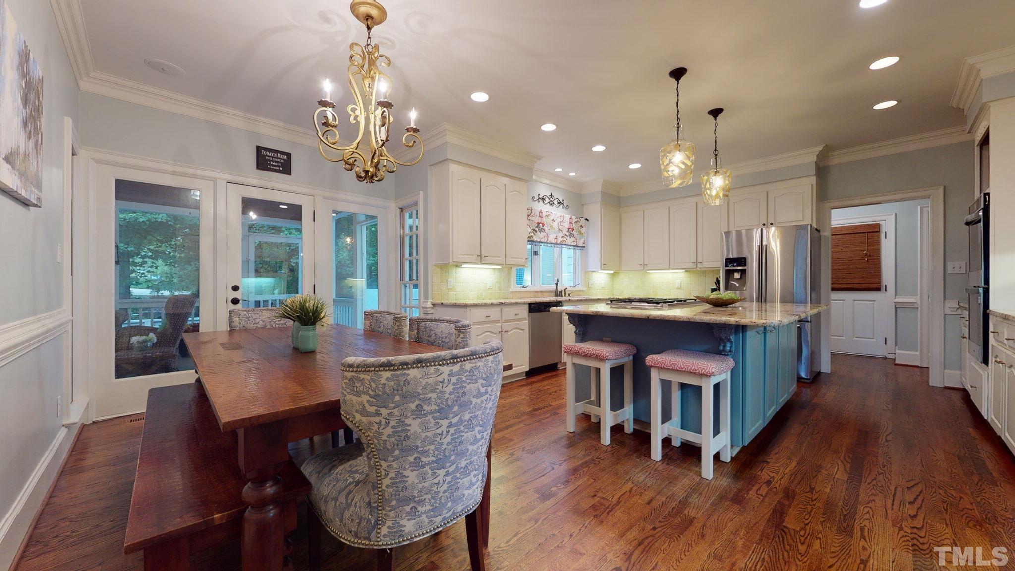 7313 Rainwater Road Raleigh, NC 27615 - Photo 11 of 30 a view of a dining room with furniture wooden floor and chandelier