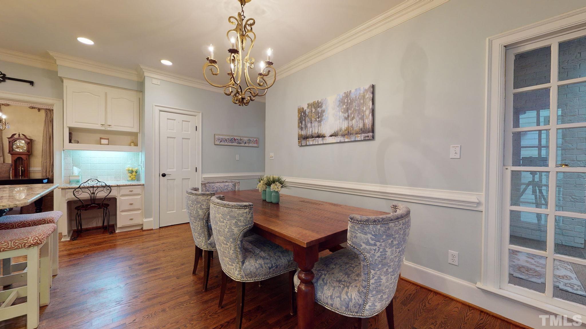 7313 Rainwater Road Raleigh, NC 27615 - Photo 14 of 30 a view of a dining room with furniture and wooden floor