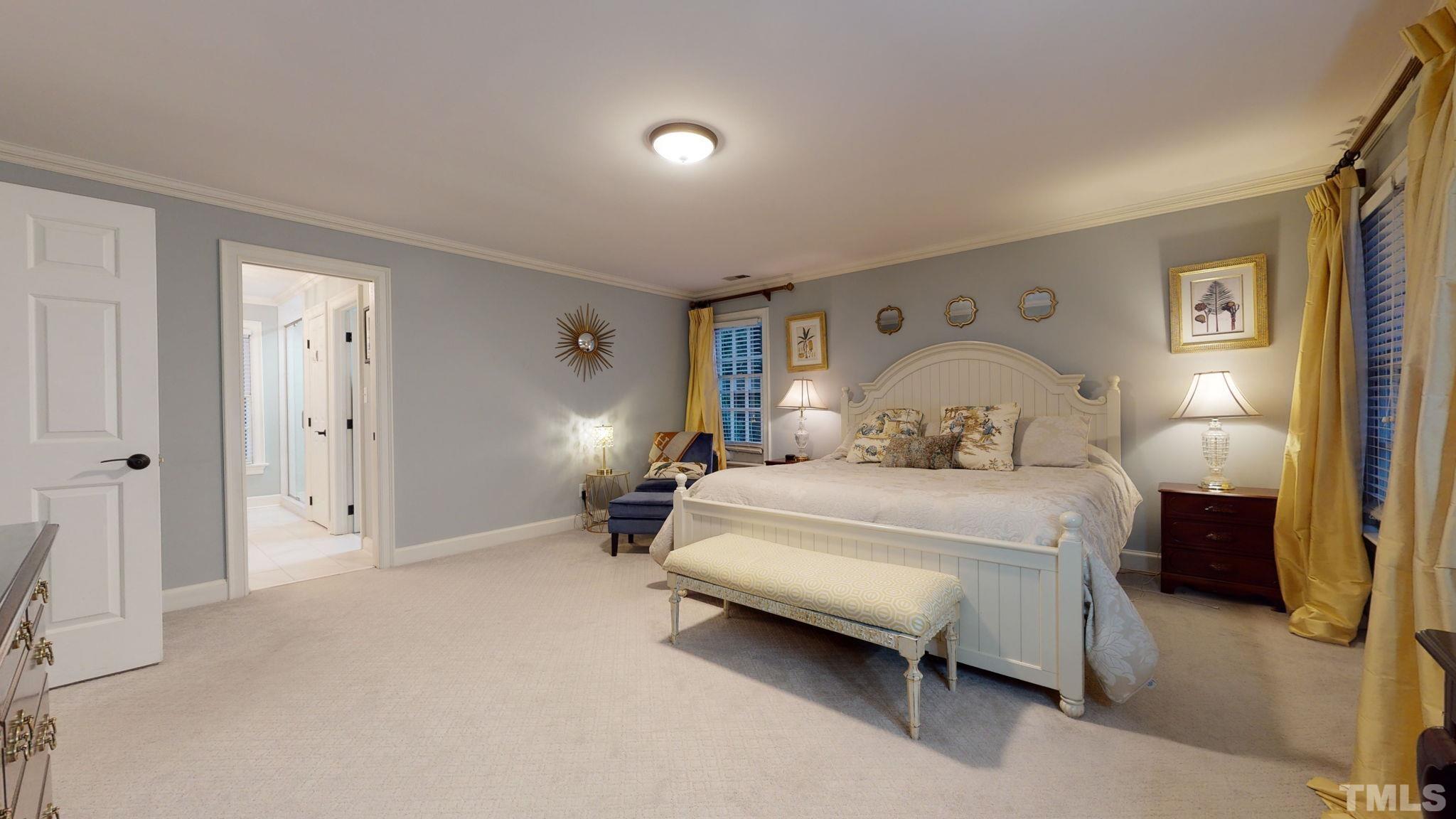 7313 Rainwater Road Raleigh, NC 27615 - Photo 17 of 30 a bedroom with a bed and lamp