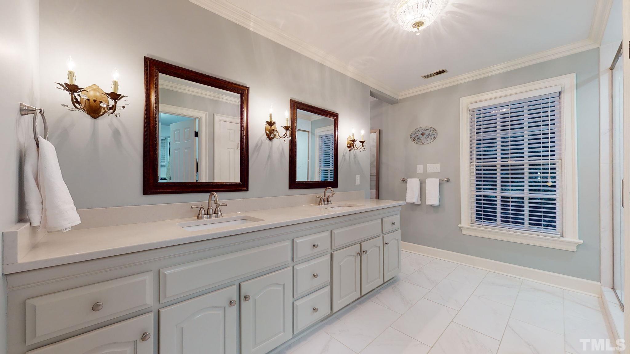 7313 Rainwater Road Raleigh, NC 27615 - Photo 18 of 30 a bathroom with a sink and a mirror