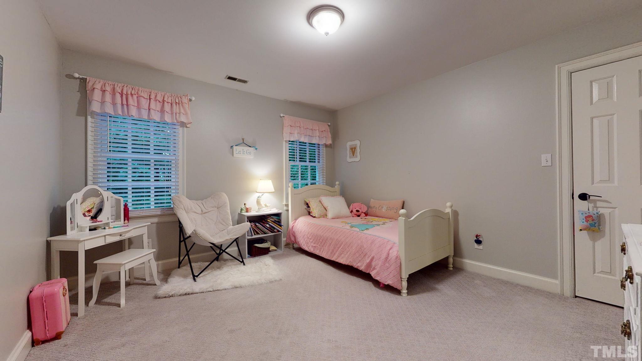 7313 Rainwater Road Raleigh, NC 27615 - Photo 21 of 30 a bedroom with furniture and a window