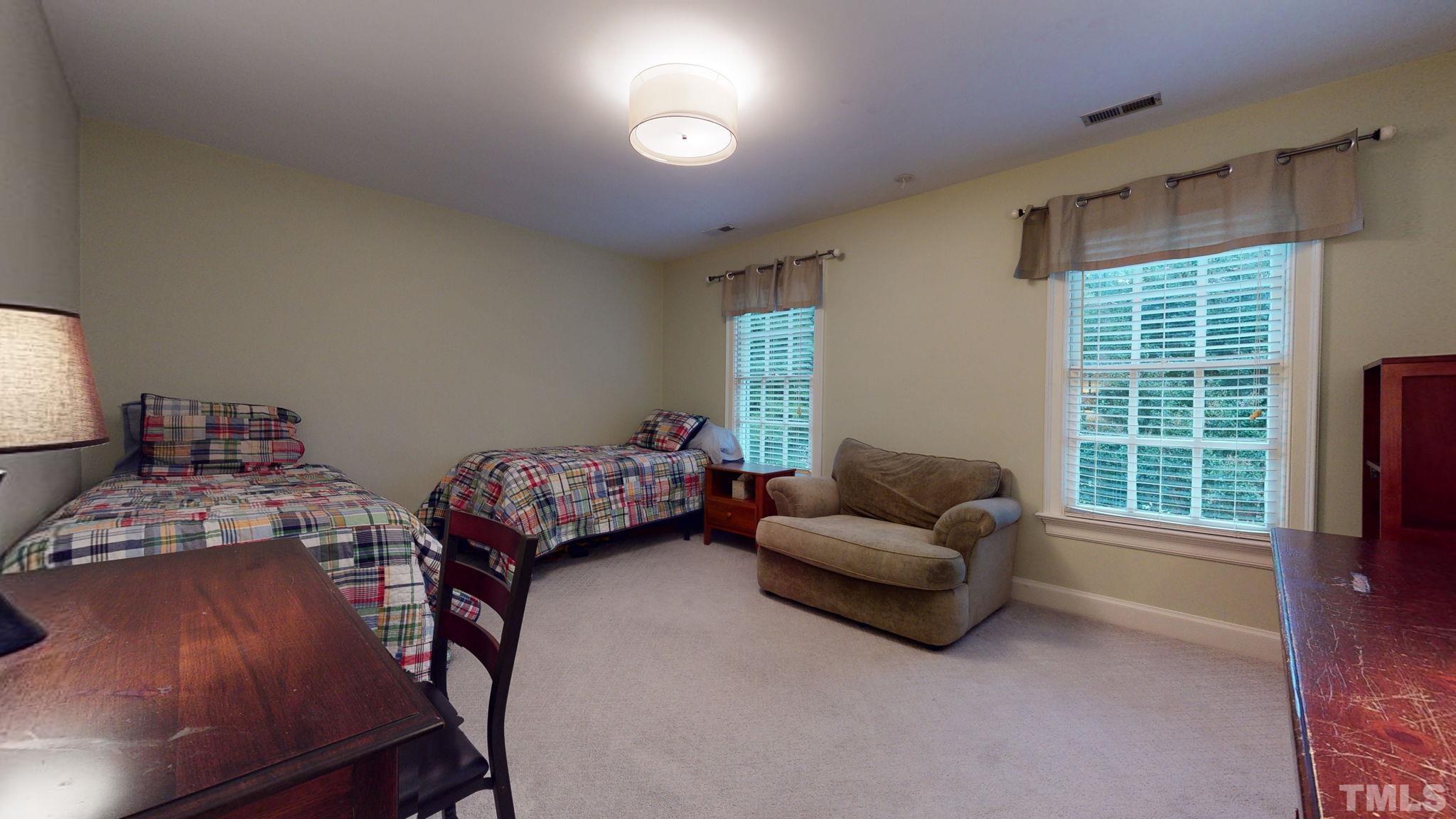 7313 Rainwater Road Raleigh, NC 27615 - Photo 22 of 30 a living room with furniture and a flat screen tv