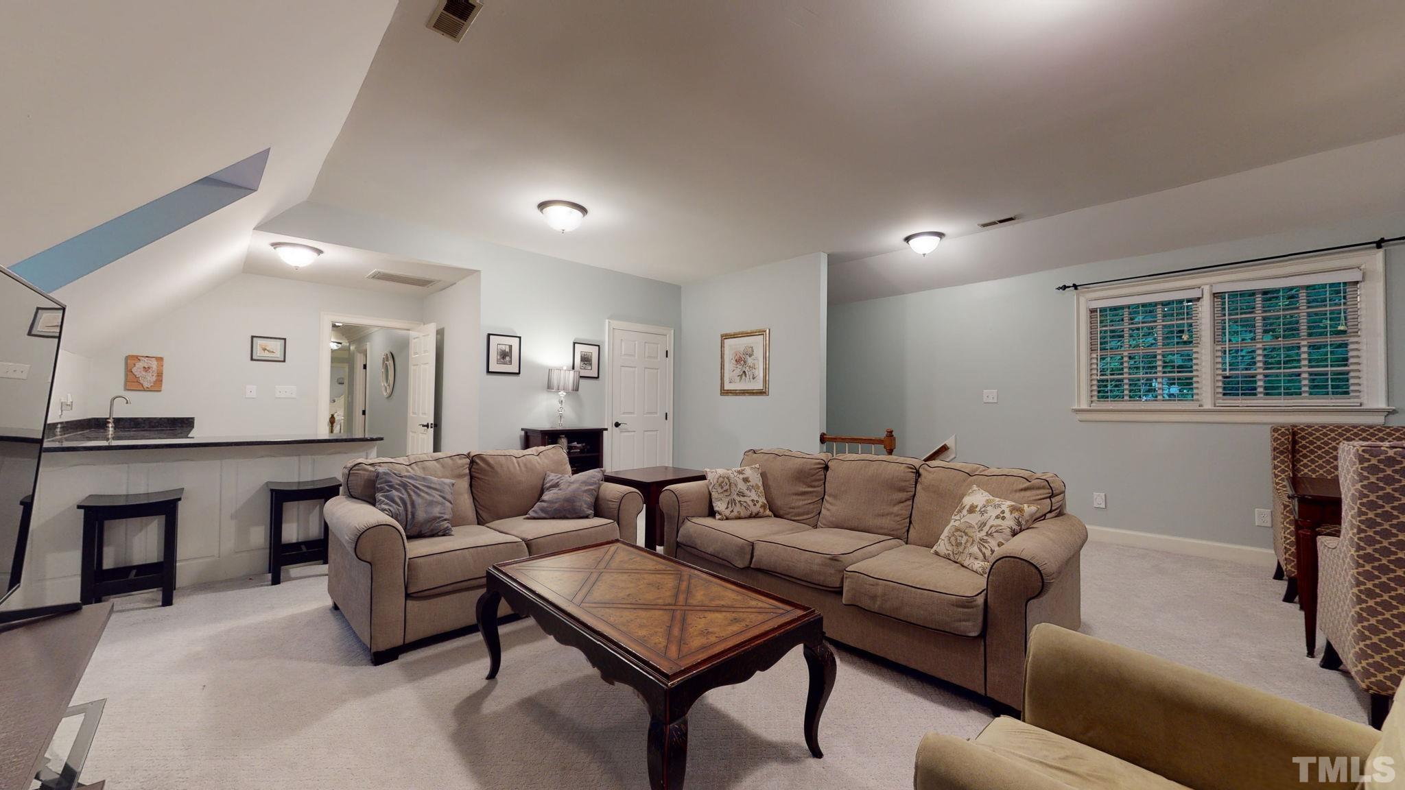 7313 Rainwater Road Raleigh, NC 27615 - Photo 24 of 30 a living room with furniture and a table