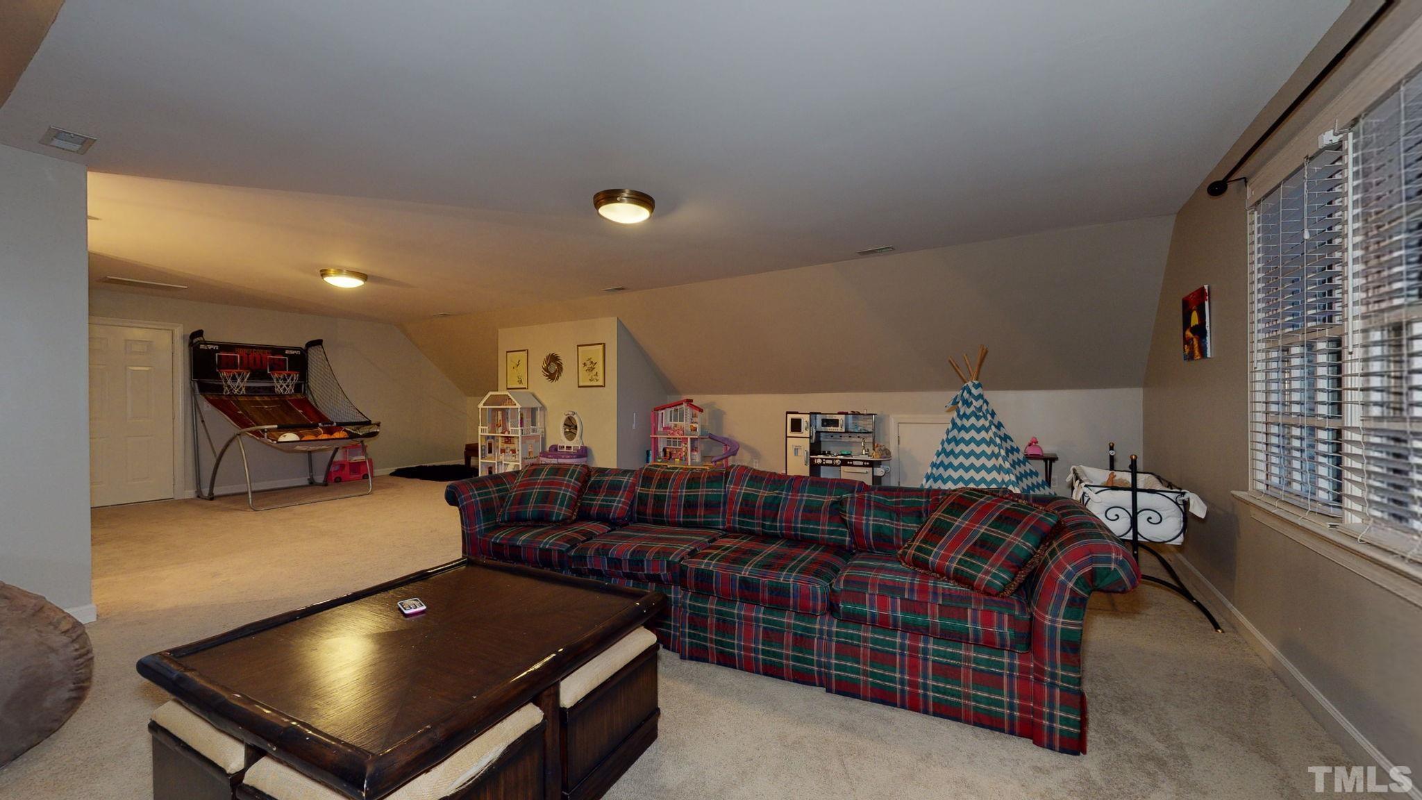 7313 Rainwater Road Raleigh, NC 27615 - Photo 25 of 30 a room with lots of furniture and white walls
