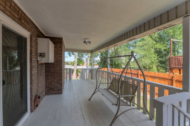 11072 Windy Peak Ridge Drive, Unit 32 Sandy, UT 84094 - Photo 6 of 30 Covered porch featuring a painted wood-finish deck and white railing
