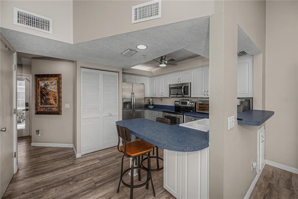 2255 North Beach Road, Unit 20 Englewood, FL 34223 - Photo 17 of 50 a view of kitchen with cabinets table and chairs