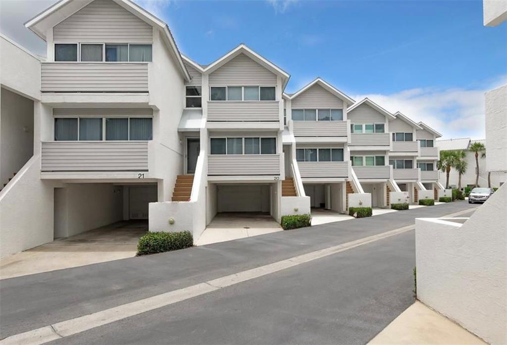 2255 North Beach Road, Unit 20 Englewood, FL 34223 - Photo 2 of 50 a front view of a house with a yard and parking space