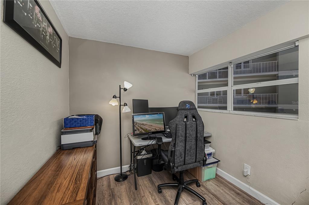 2255 North Beach Road, Unit 20 Englewood, FL 34223 - Photo 25 of 50 a view of a workspace with furniture and wooden floor