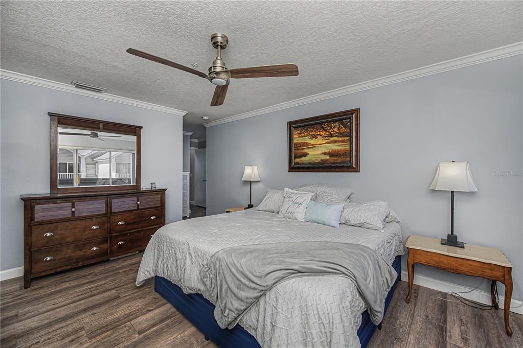 2255 North Beach Road, Unit 20 Englewood, FL 34223 - Photo 27 of 50 a bedroom with a bed and a lamp on dresser