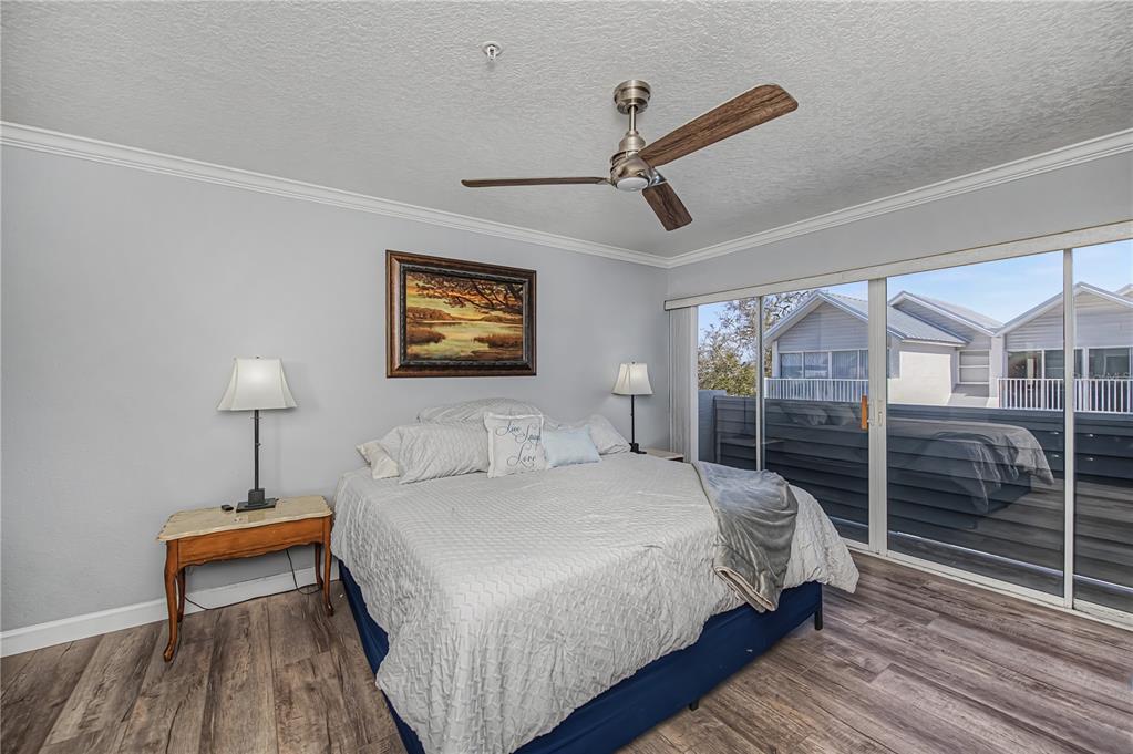 2255 North Beach Road, Unit 20 Englewood, FL 34223 - Photo 28 of 50 a bedroom with a bed and a night stand