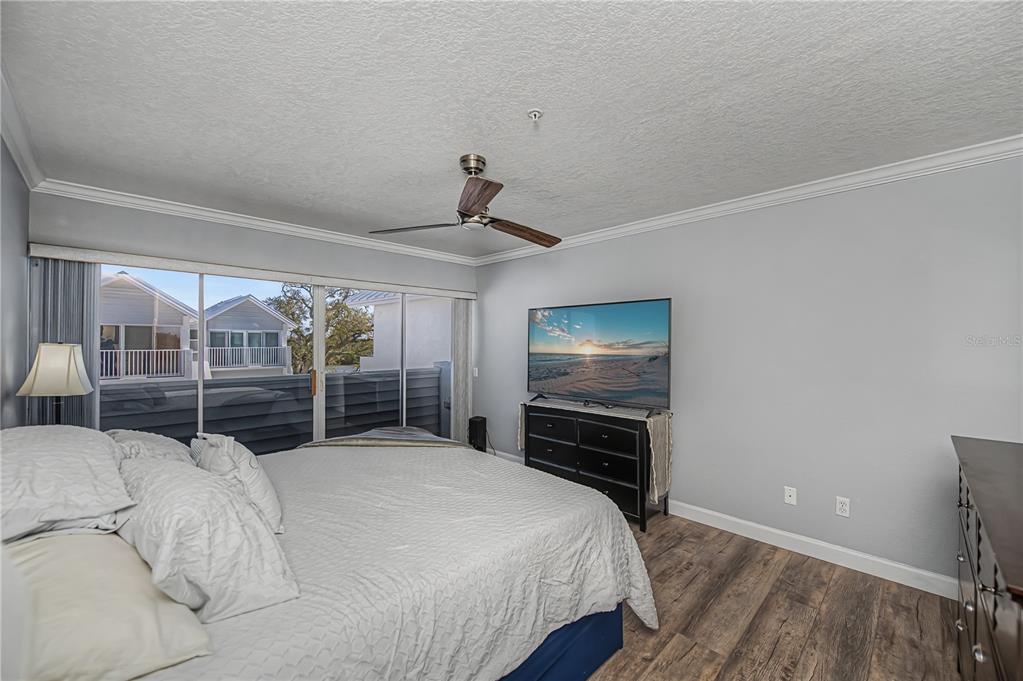 2255 North Beach Road, Unit 20 Englewood, FL 34223 - Photo 29 of 50 a bedroom with a bed and large window