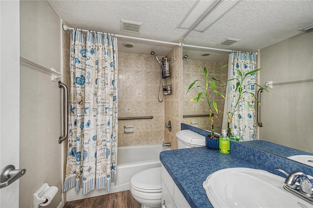 2255 North Beach Road, Unit 20 Englewood, FL 34223 - Photo 30 of 50 a bathroom with a granite countertop sink a toilet and shower
