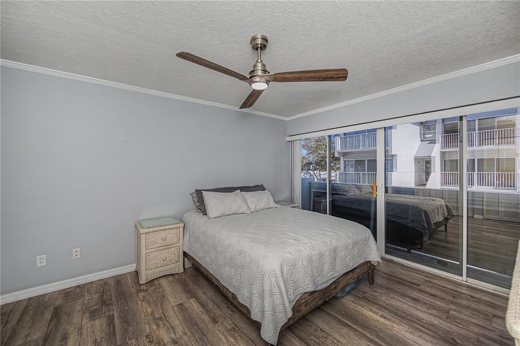 2255 North Beach Road, Unit 20 Englewood, FL 34223 - Photo 31 of 50 a bedroom with a bed and wooden floor