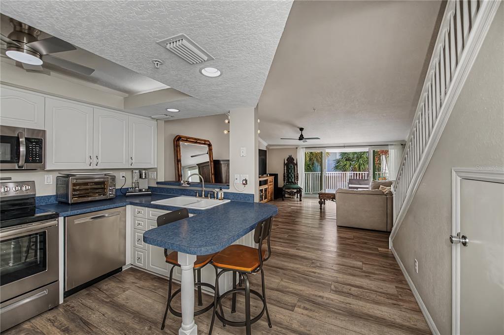 2255 North Beach Road, Unit 20 Englewood, FL 34223 - Photo 10 of 50 a kitchen with a table chairs microwave and cabinets