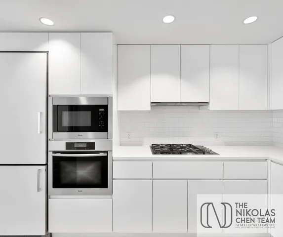 a view of kitchen with microwave and refrigerator
