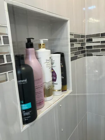 a white toilet sitting next to a bathroom sink