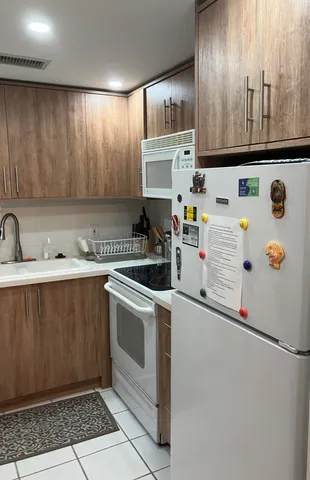 a kitchen with stainless steel appliances a refrigerator sink and cabinets