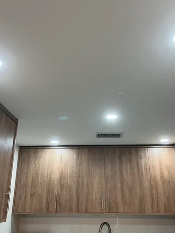 a bedroom with two beds and a chandelier