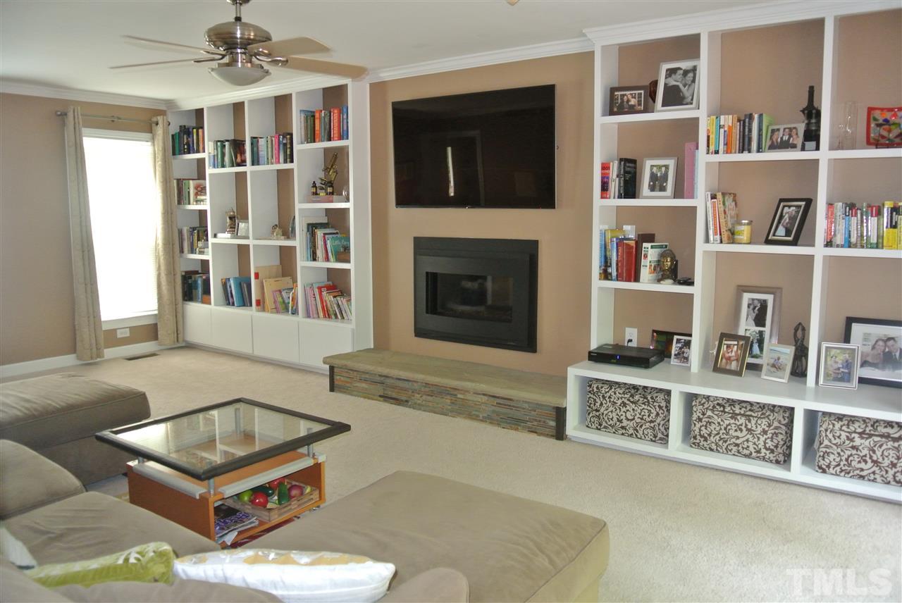 3108 Ridgestone Parkway Durham, NC 27712 - Photo 3 of 14 Beautiful family room with built-in bookshelves & gas fireplace with stone hearth.