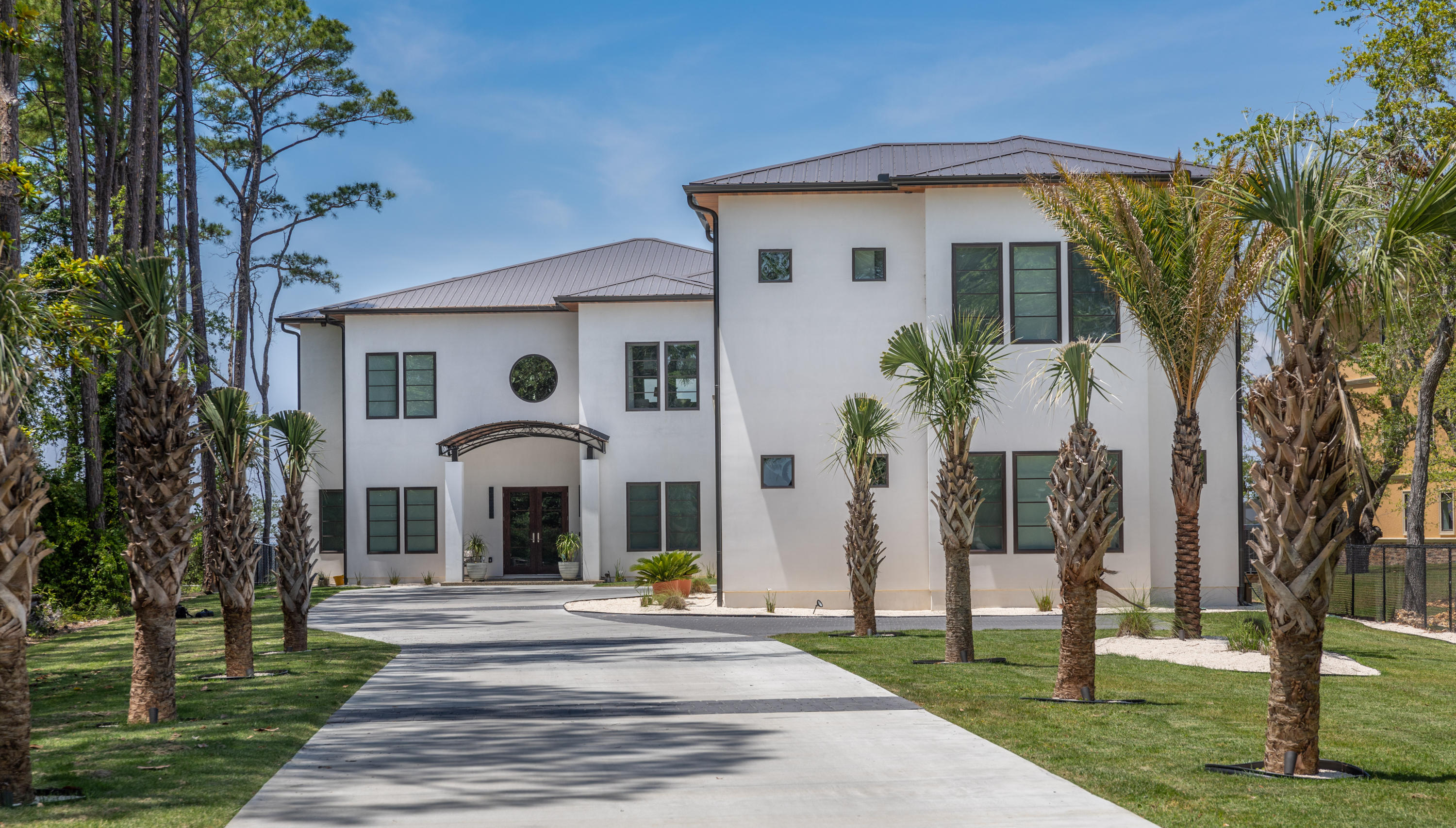 405 Driftwood Point Road Santa Rosa Beach, FL 32459 - Photo 3 of 57 a front view of a house with a garden