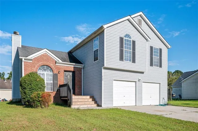 a front view of a house with a yard