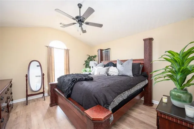 a bed room with a bed and a potted plant