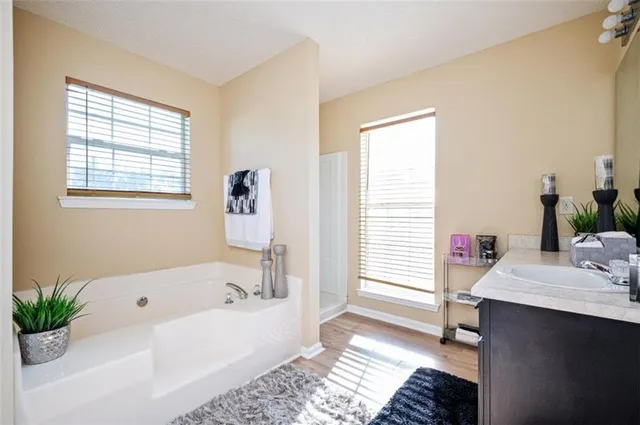 a bathroom with a bathtub sink and a window