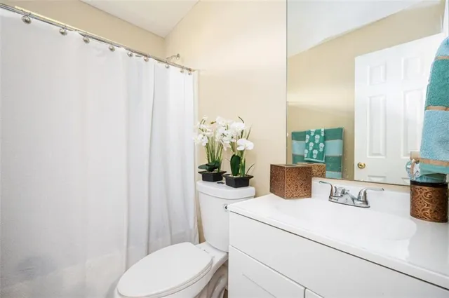 a bathroom with a toilet a sink and a window