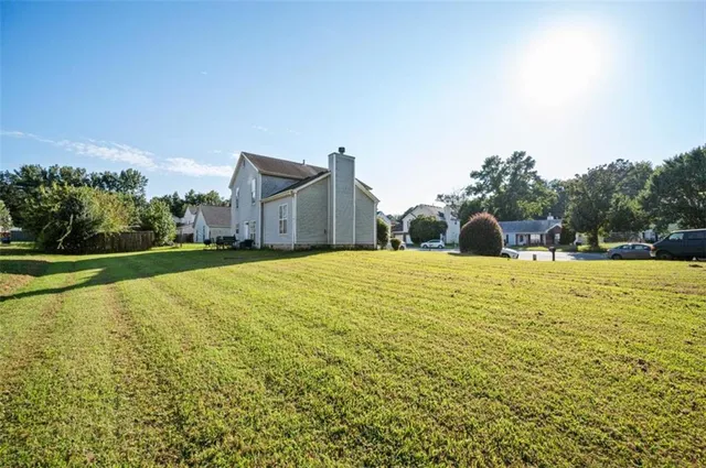 a house view with swimming pool in front of it
