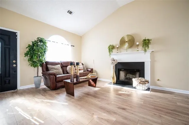 a living room with furniture and a fireplace