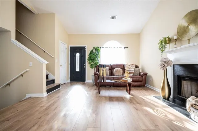 a living room with furniture and a fireplace
