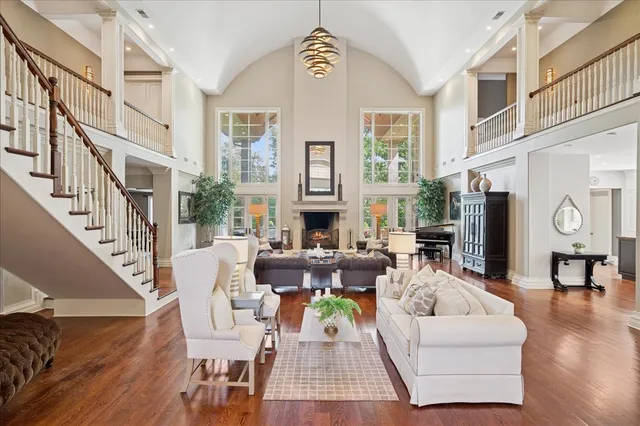 a living room with fireplace furniture and a wooden floor