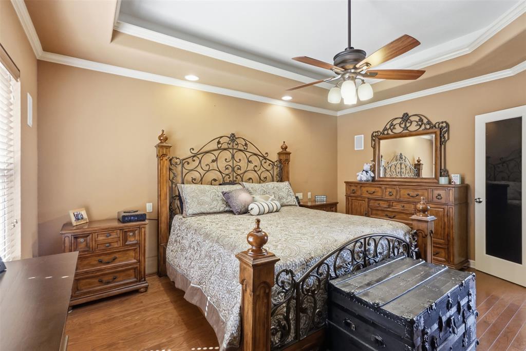 207 Dennis Road Lipan, TX 76462 - Photo 4 of 40 Tray ceiling with crown molding, recessed lighting, wood-finish flooring, and a ceiling fan with integrated lighting
