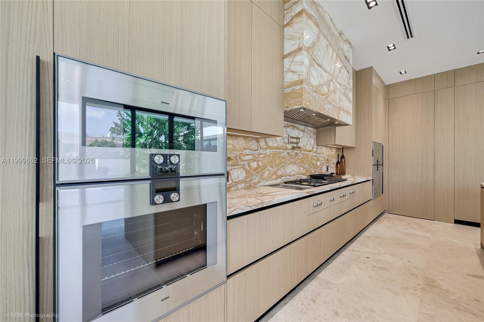 770 Lake Road Miami, FL 33137 - Photo 14 of 39 a kitchen with stainless steel appliances kitchen island granite countertop a refrigerator and a stove