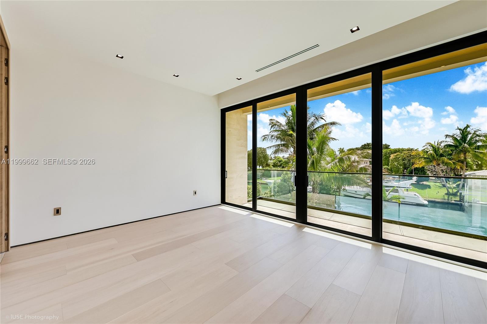 770 Lake Road Miami, FL 33137 - Photo 21 of 39 a view of an empty room with wooden floor and windows