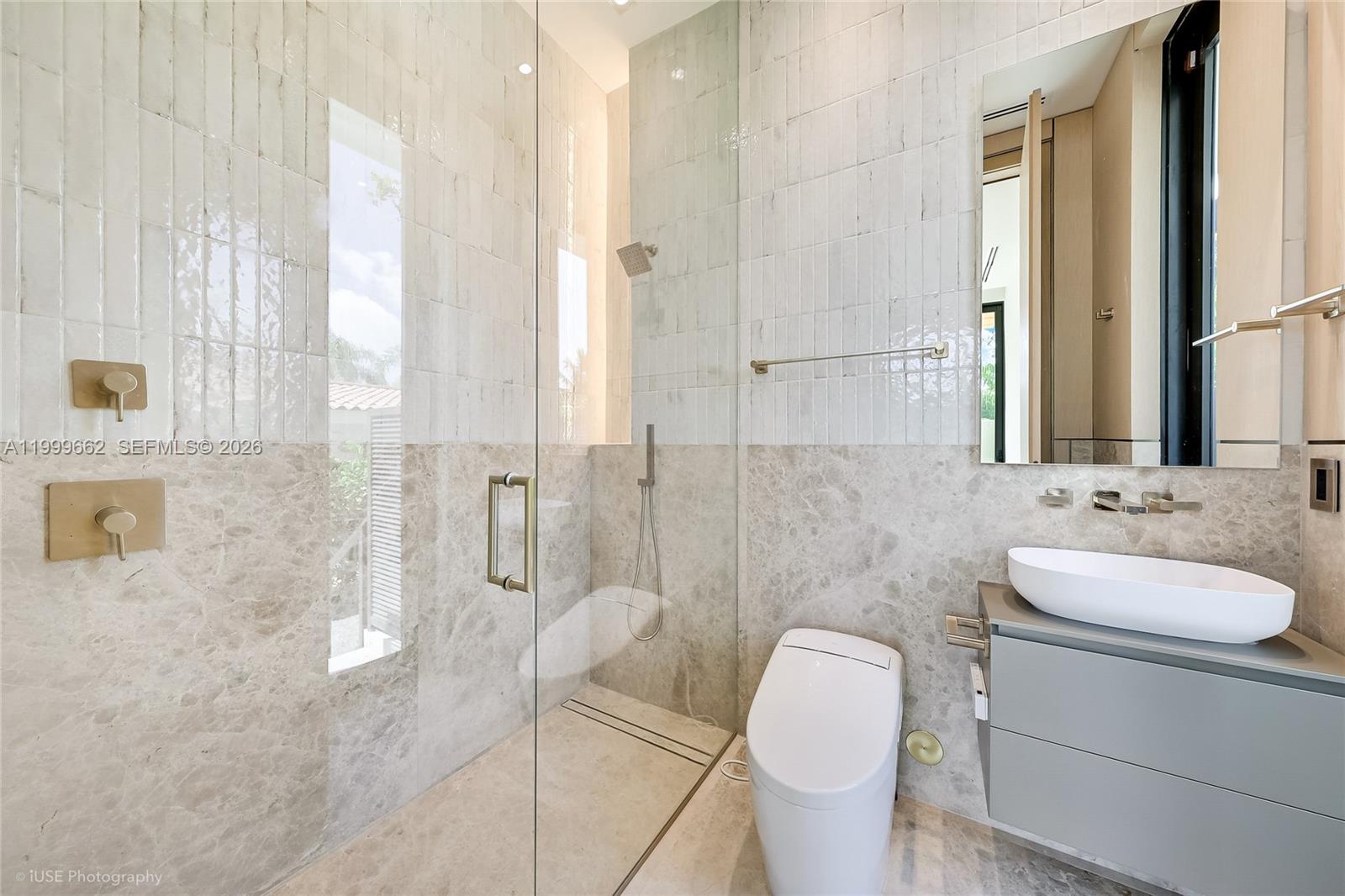 770 Lake Road Miami, FL 33137 - Photo 29 of 39 a bathroom with a granite countertop sink a toilet and shower