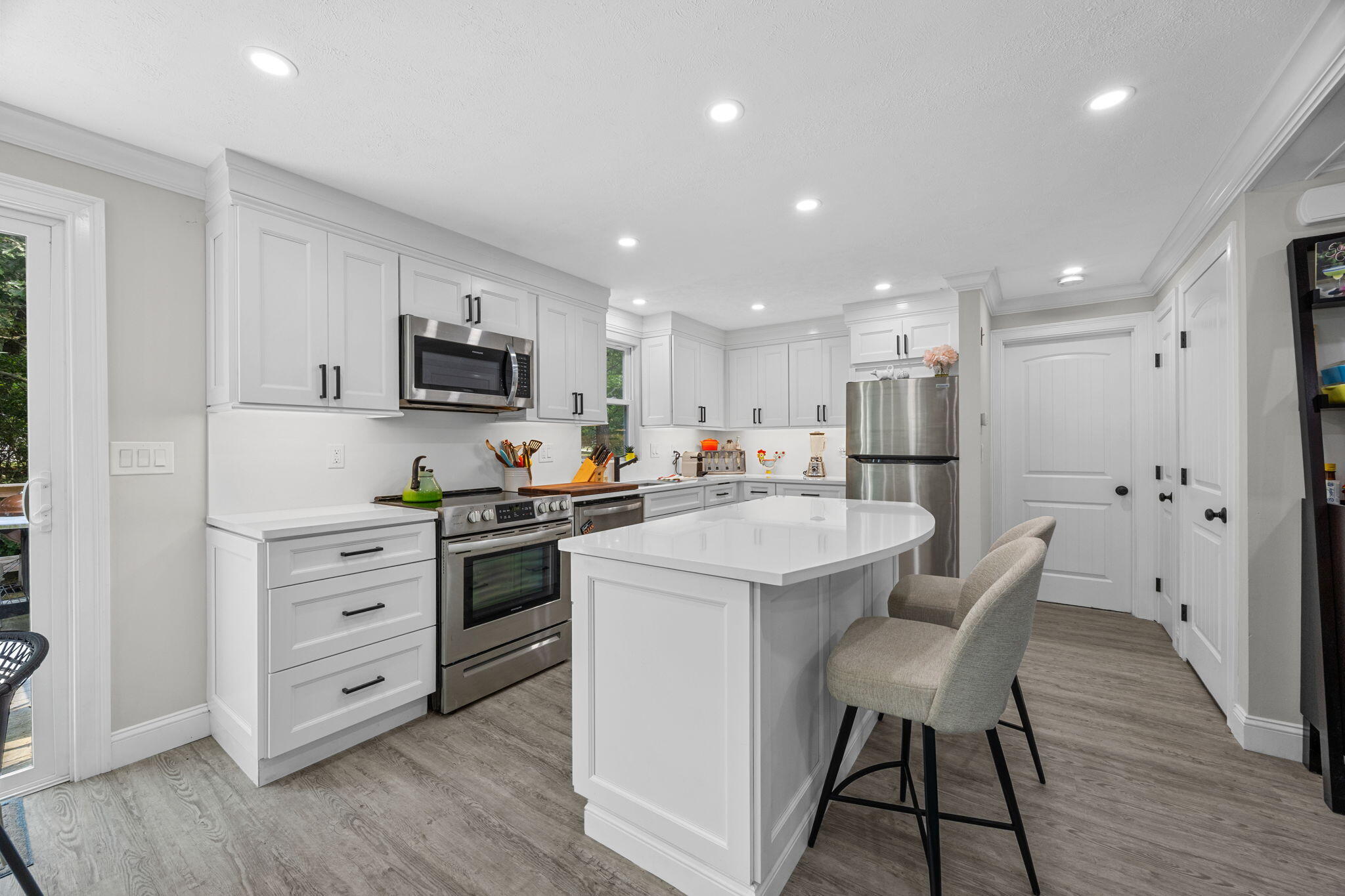 140 Noisy Hole Road Mashpee, MA 02649 - Photo 11 of 53 a kitchen with white cabinets and stainless steel appliances