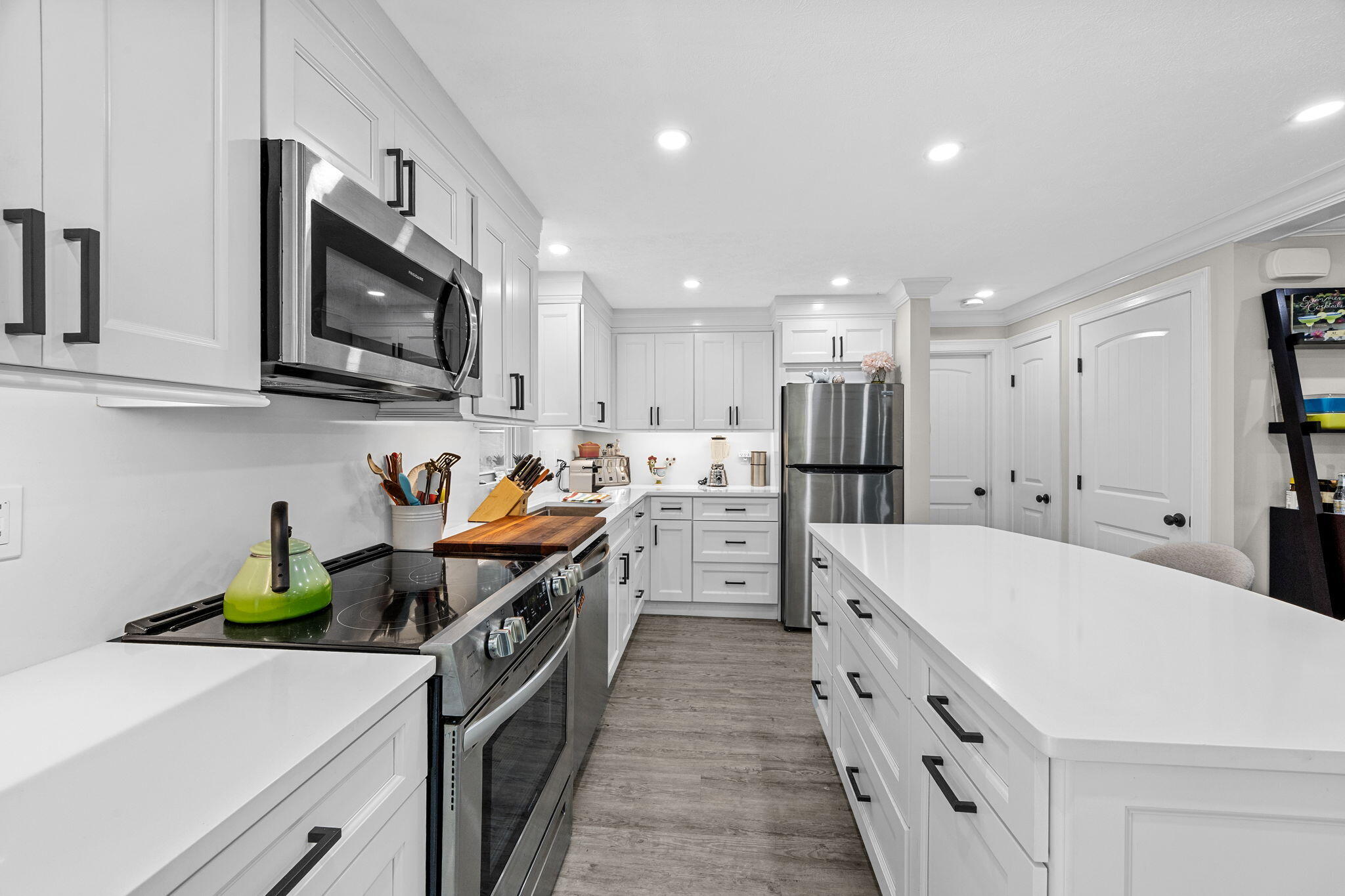 140 Noisy Hole Road Mashpee, MA 02649 - Photo 13 of 53 a kitchen with stainless steel appliances a stove sink microwave and cabinets