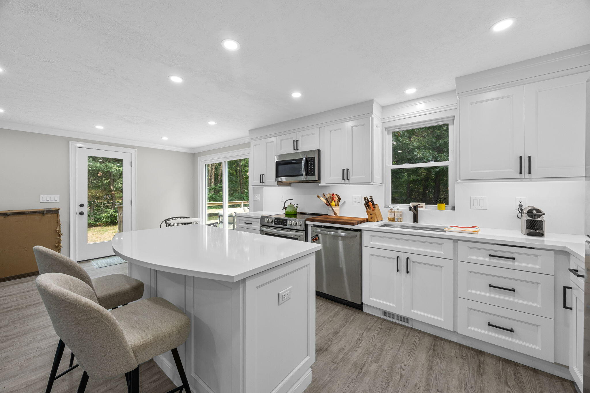 140 Noisy Hole Road Mashpee, MA 02649 - Photo 15 of 53 a kitchen with sink a microwave and cabinets