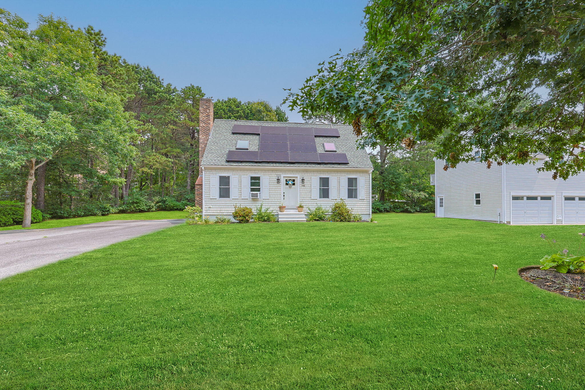 140 Noisy Hole Road Mashpee, MA 02649 - Photo 2 of 53 a view of house with backyard and a garden