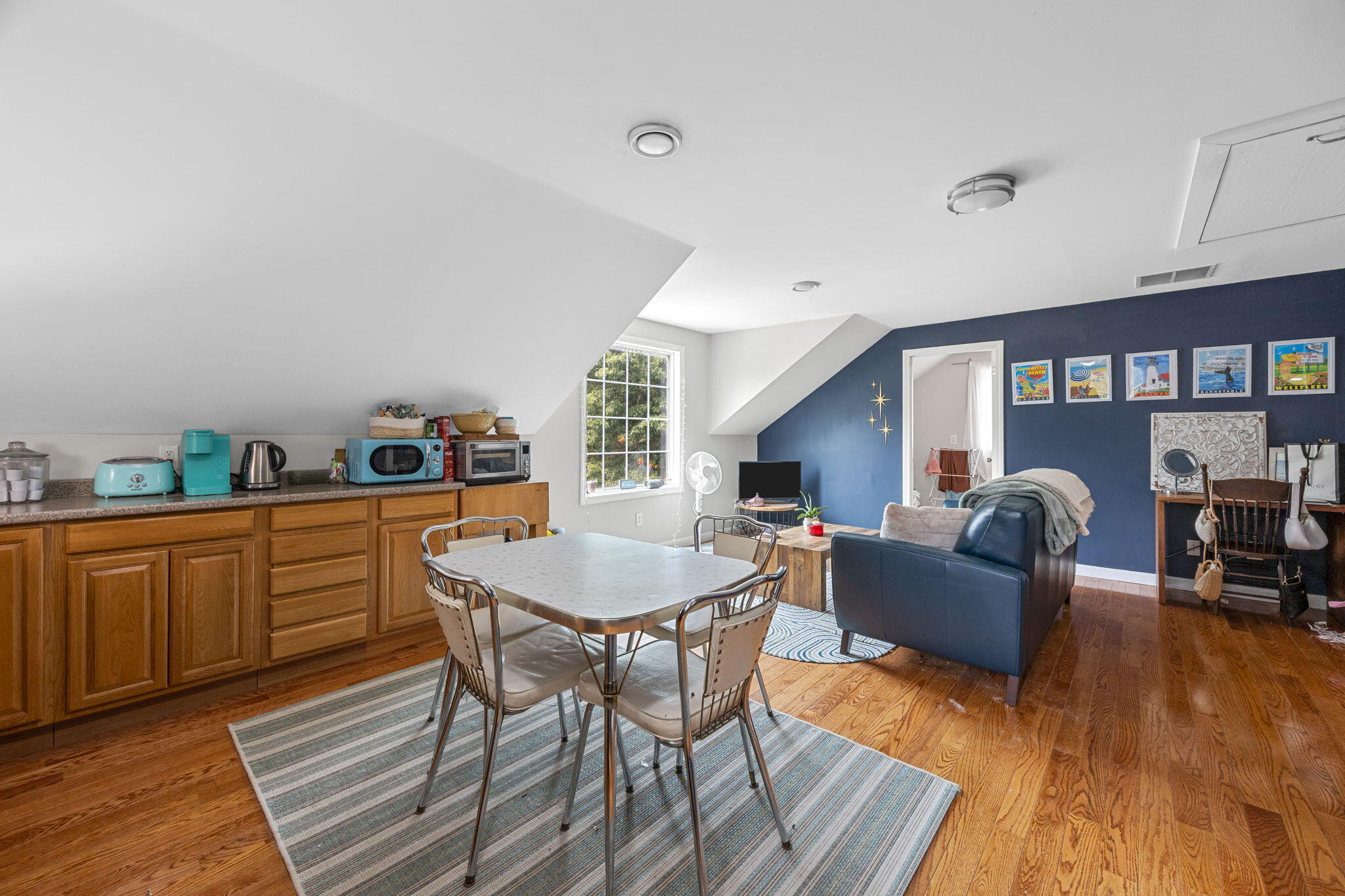 140 Noisy Hole Road Mashpee, MA 02649 - Photo 29 of 53 a living room with furniture a dining table and wooden floor