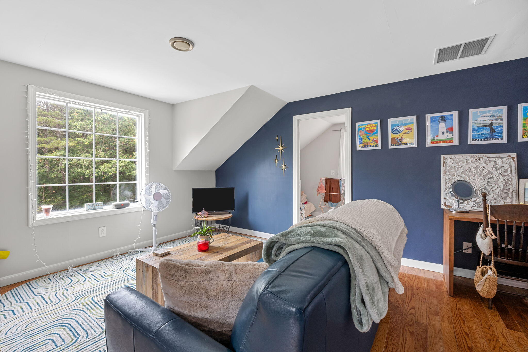 140 Noisy Hole Road Mashpee, MA 02649 - Photo 32 of 53 a bedroom with furniture and a wooden floor